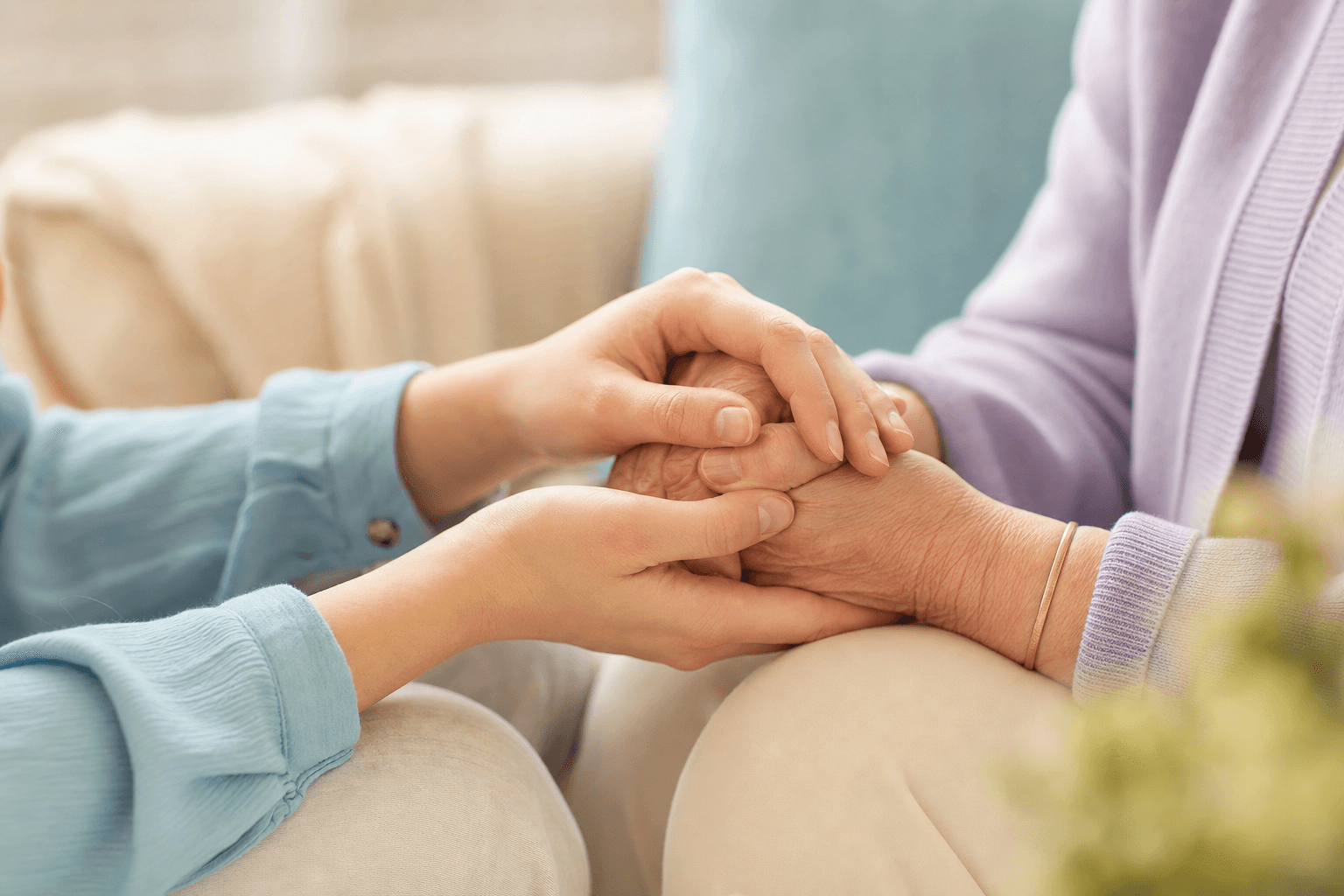 A calm, connected moment between two people holding hands